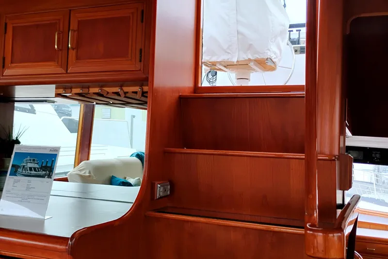Slide: The Image of Interior of 1985 Ocean Alexander Custom Aft Deck Motoryacht with wooden cabinetry and stairs. - 12