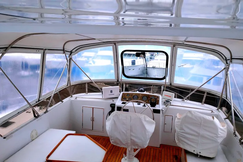 Slide: The Image of 1985 Ocean Alexander Custom Aft Deck Motoryacht helm with covered seats and navigation equipment. - 14