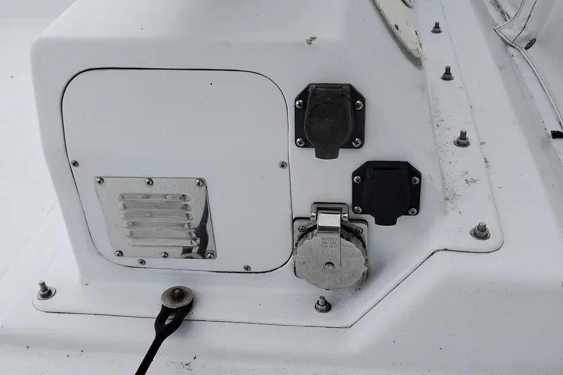 Slide: The Image of 1985 Ocean Alexander Custom Aft Deck Motoryacht electrical panel with outlets and cover. - 24