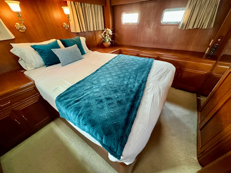 Slide: The Image of Luxurious bedroom in 1985 Ocean Alexander Custom Aft Deck Motoryacht with elegant teal accents. - 28