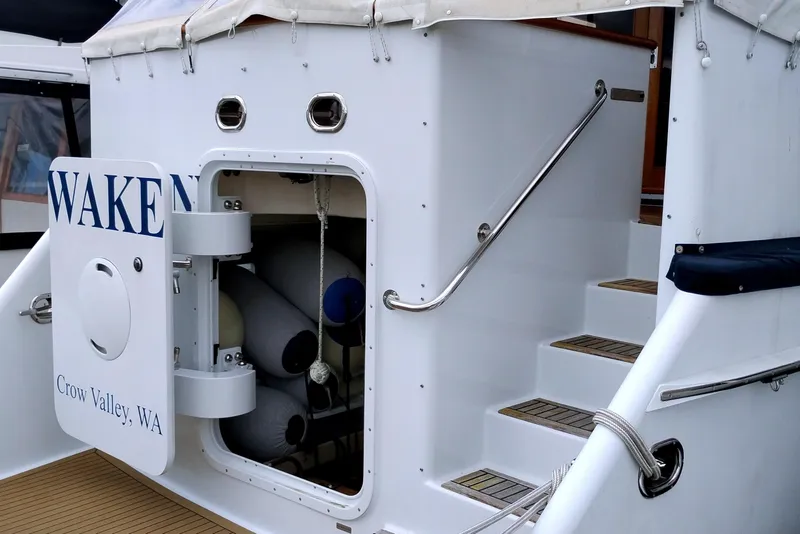 Slide: The Image of 1985 Ocean Alexander Custom Aft Deck Motoryacht with open storage compartment and steps. - 3