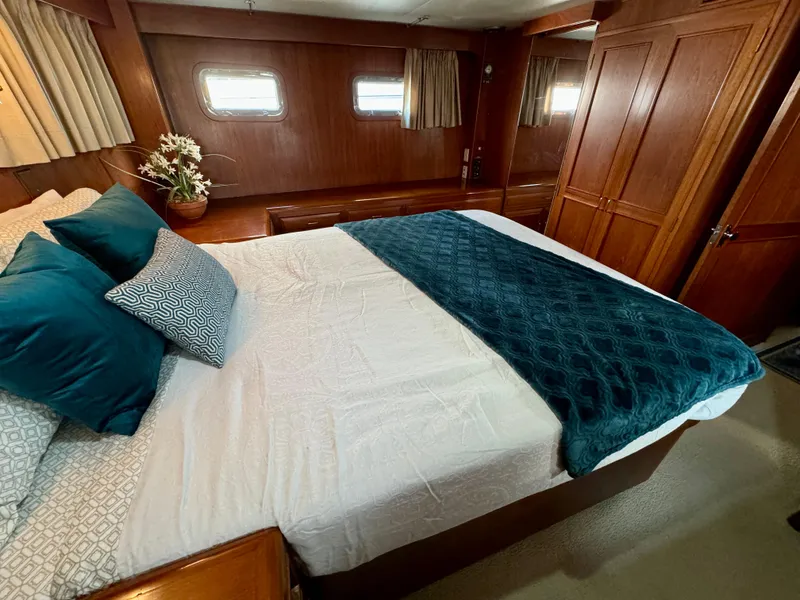 Slide: The Image of Luxurious bedroom in 1985 Ocean Alexander Custom Aft Deck Motoryacht with elegant wood paneling. - 30