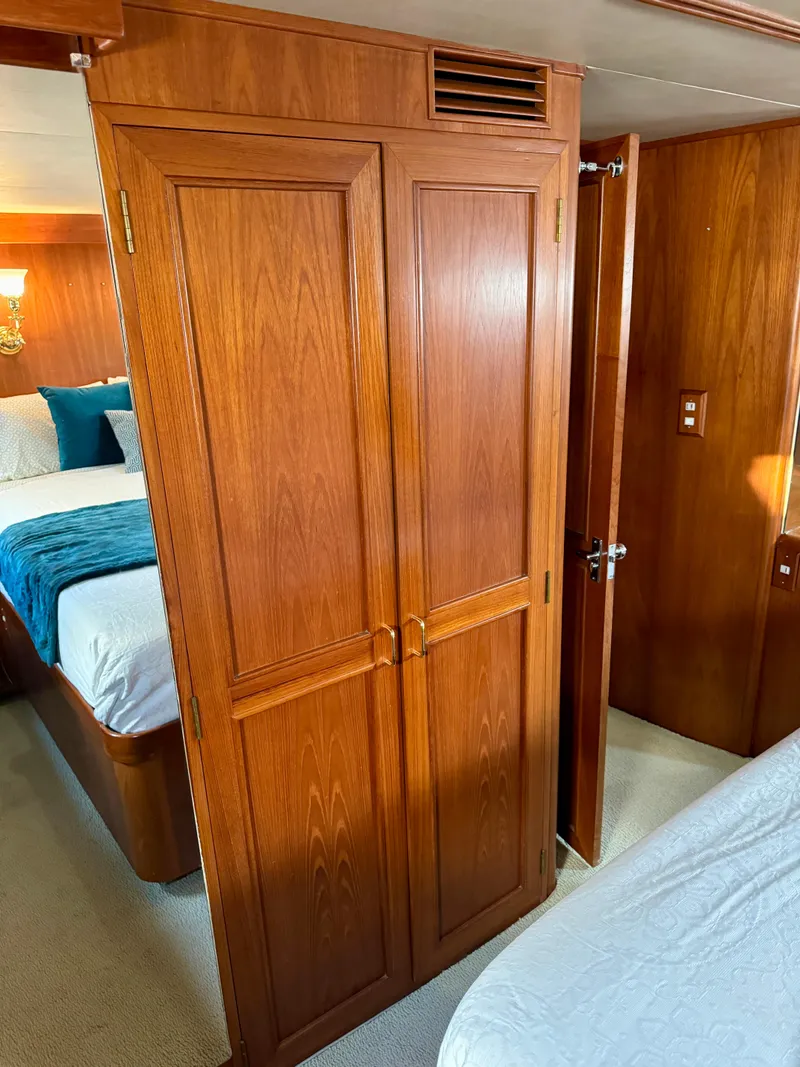 Slide: The Image of 1985 Ocean Alexander Custom Aft Deck Motoryacht interior with wooden cabinetry and cozy bedroom. - 31
