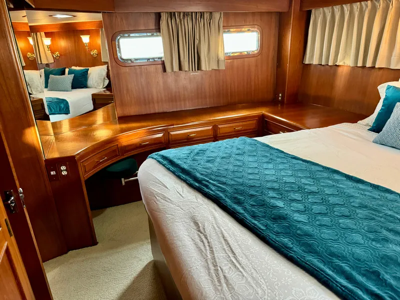 Slide: The Image of Luxurious 1985 Ocean Alexander Custom Aft Deck Motoryacht bedroom with elegant wood finish. - 33