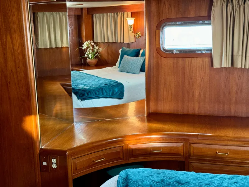 Slide: The Image of Luxurious 1985 Ocean Alexander Custom Aft Deck Motoryacht interior with elegant wood finish and cozy bedding. - 34
