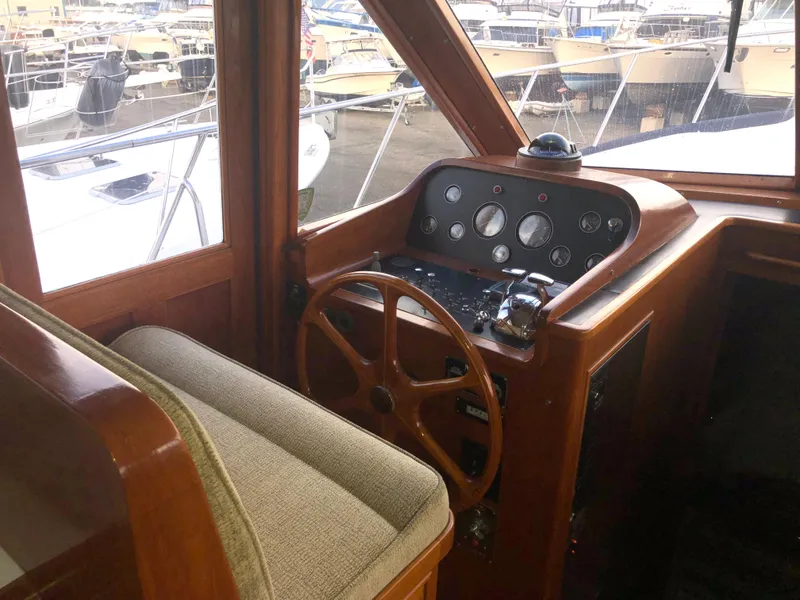 Slide: The Image of 1985 Ocean Alexander Custom Aft Deck Motoryacht helm with classic wooden steering wheel. - 38