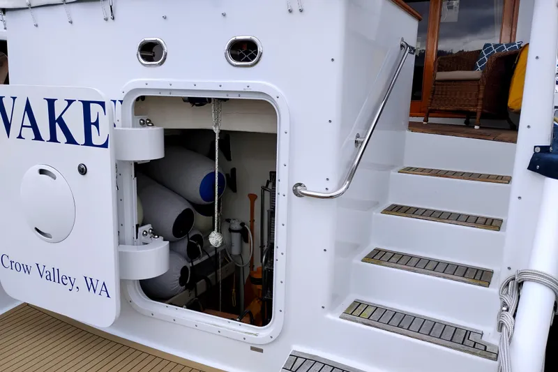 Slide: The Image of 1985 Ocean Alexander Custom Aft Deck Motoryacht with open storage compartment and stairs. - 4