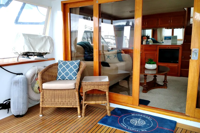Slide: The Image of 1985 Ocean Alexander Custom Aft Deck Motoryacht with cozy seating and elegant interior decor. - 5