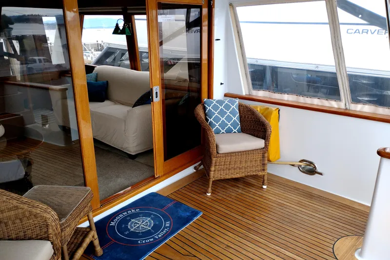 Slide: The Image of 1985 Ocean Alexander Custom Aft Deck Motoryacht with wicker seating and wooden flooring. - 7