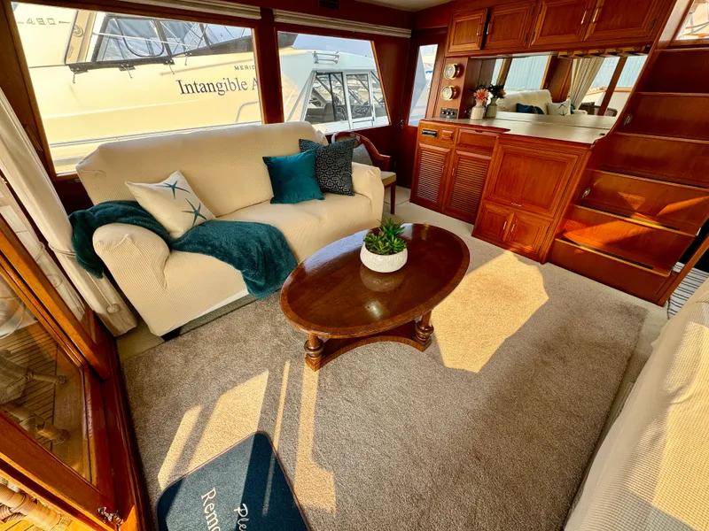 Slide: The Image of Luxurious 1985 Ocean Alexander Custom Aft Deck Motoryacht interior with cozy seating and elegant decor. - 9