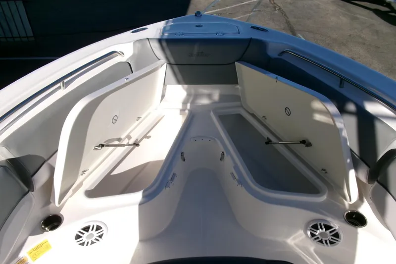 Slide: The Image of 2023 NauticStar 2102 Legacy boat interior with open storage compartments. - 11