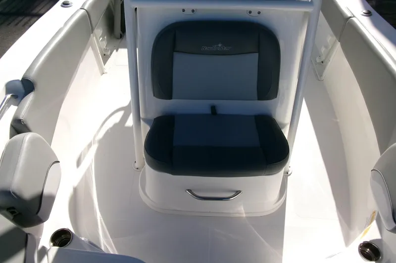 Slide: The Image of 2023 NauticStar 2102 Legacy boat interior with cushioned seating and sleek design. - 12
