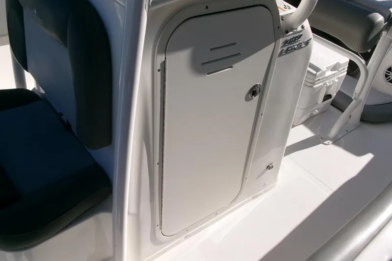 Slide: The Image of 2023 NauticStar 2102 Legacy boat interior with storage compartment and seating. - 14