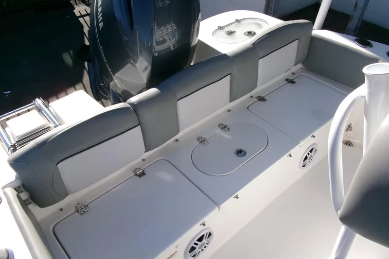 Slide: The Image of 2023 NauticStar 2102 Legacy boat interior with seating and storage compartments. - 21
