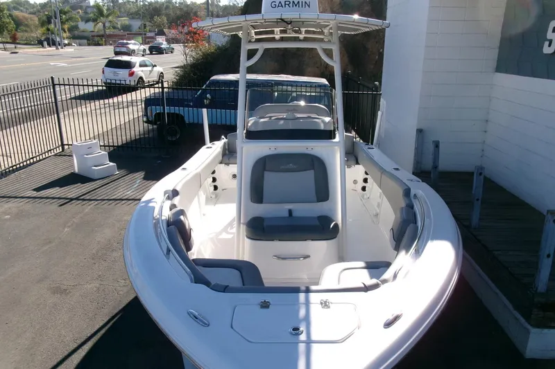Slide: The Image of 2023 NauticStar 2102 Legacy boat with Garmin equipment, parked outdoors. - 27