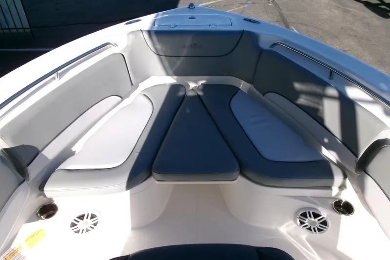 Slide: The Image of 2023 NauticStar 2102 Legacy boat interior with cushioned seating and cup holders. - 6