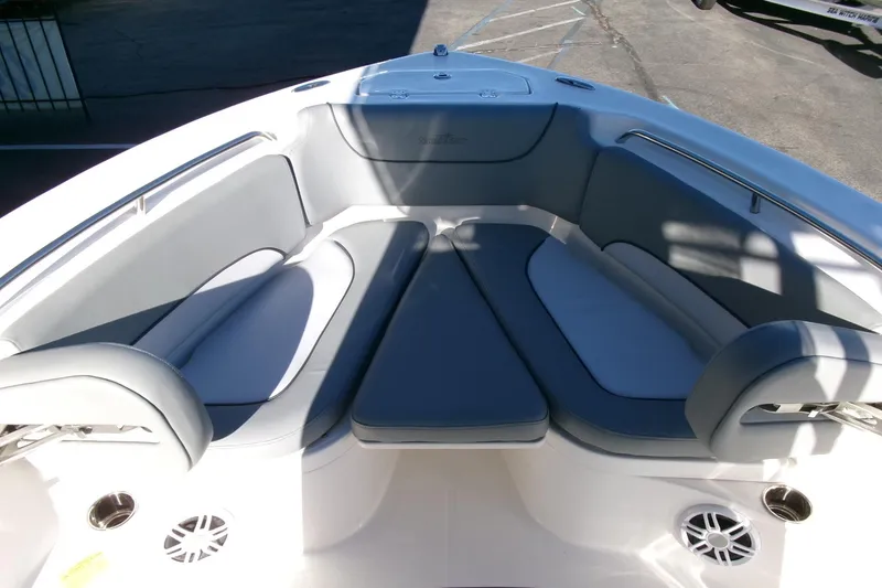 Slide: The Image of 2023 NauticStar 2102 Legacy boat interior with cushioned seating and cup holders. - 7