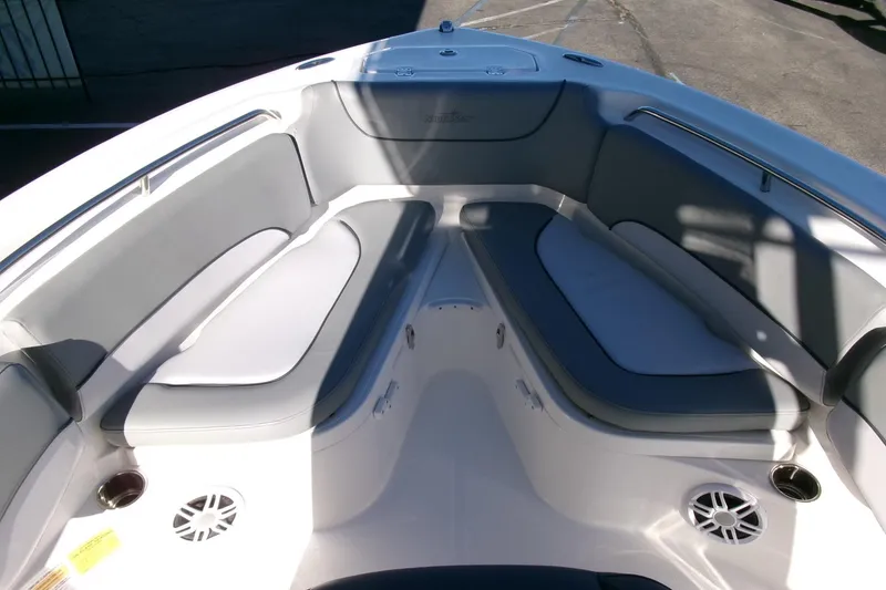 Slide: The Image of 2023 NauticStar 2102 Legacy boat interior with cushioned seating and cup holders. - 8