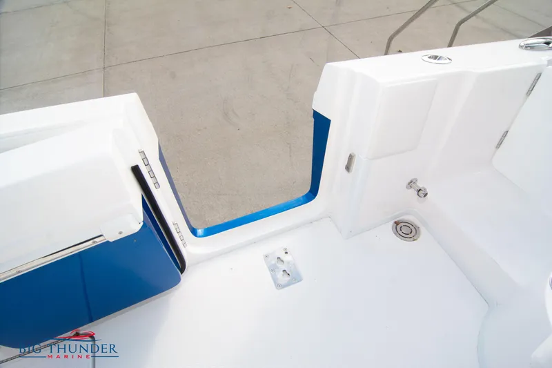 Slide: The Image of 2023 Fountain 34 Center Console boat deck with blue accents and open hatch. - 12