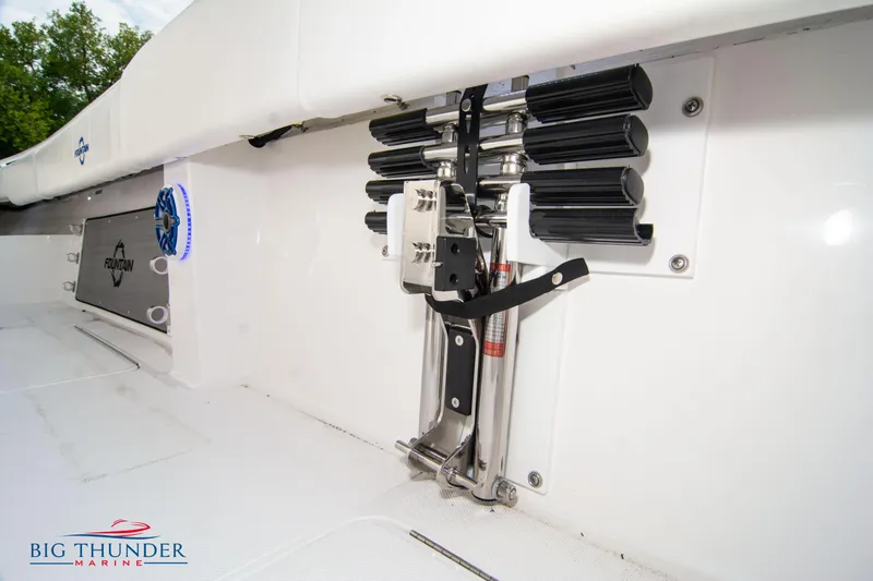 Slide: The Image of 2023 Fountain 34 Center Console boat interior with rod holders and branded speaker. - 13