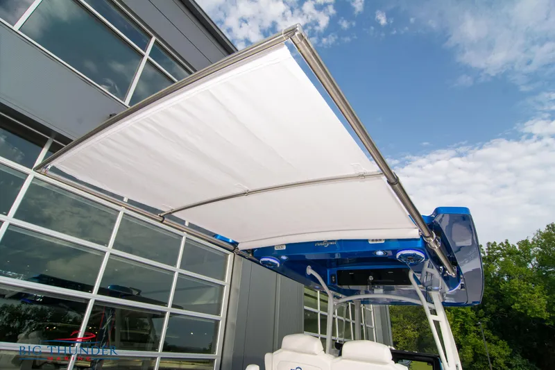 Slide: The Image of 2023 Fountain 34 Center Console boat with extended canopy, outdoor setting. - 15