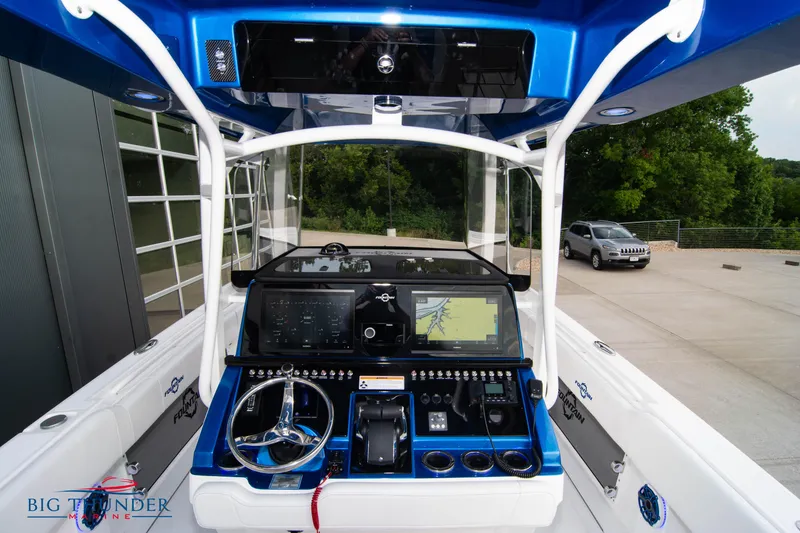 Slide: The Image of 2023 Fountain 34 Center Console boat dashboard with advanced navigation system and controls. - 17