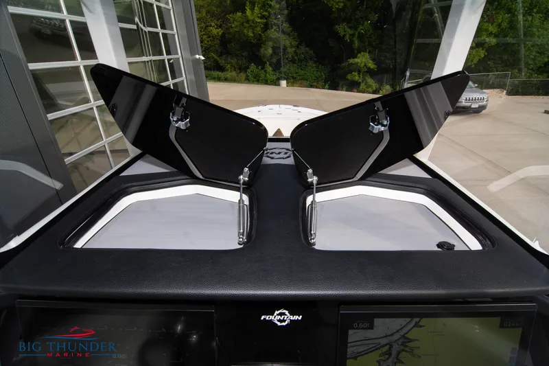 Slide: The Image of 2023 Fountain 34 Center Console boat dashboard with open hatches, showcasing modern design. - 18
