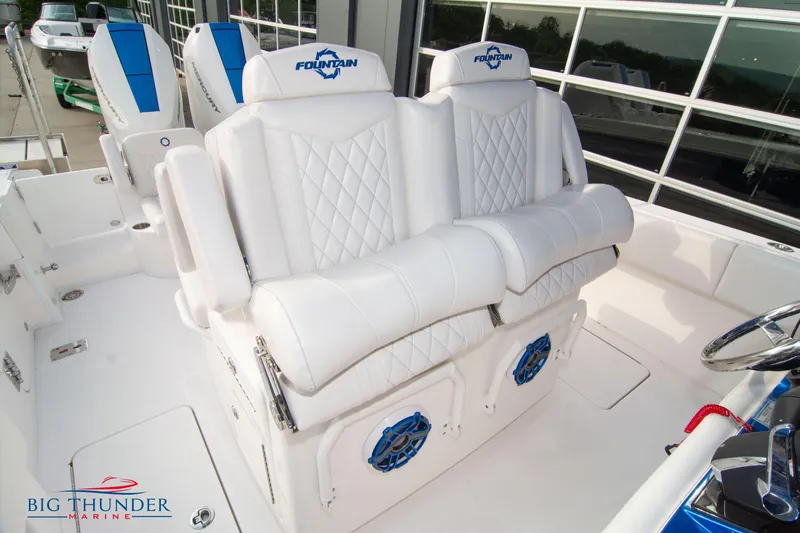 Slide: The Image of 2023 Fountain 34 Center Console boat interior with white seating and blue accents. - 19