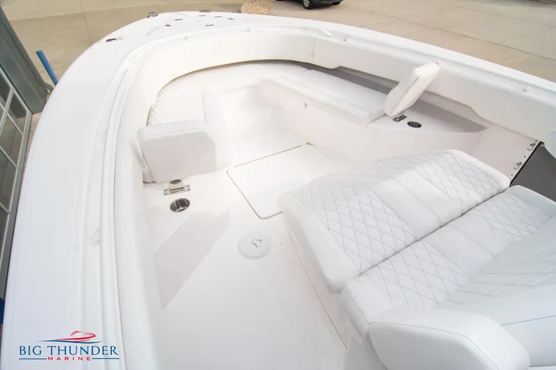 Slide: The Image of 2023 Fountain 34 Center Console boat with luxurious white seating and spacious deck. - 22