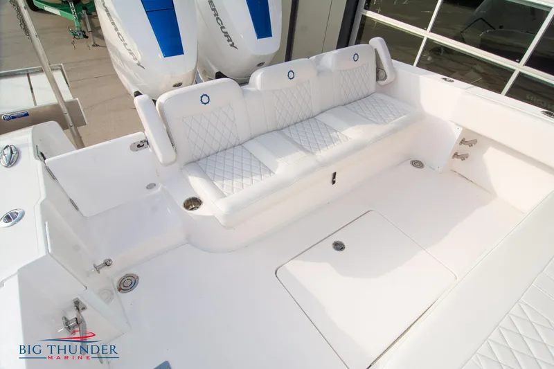 Slide: The Image of 2023 Fountain 34 Center Console boat with white seating and dual Mercury engines. - 9