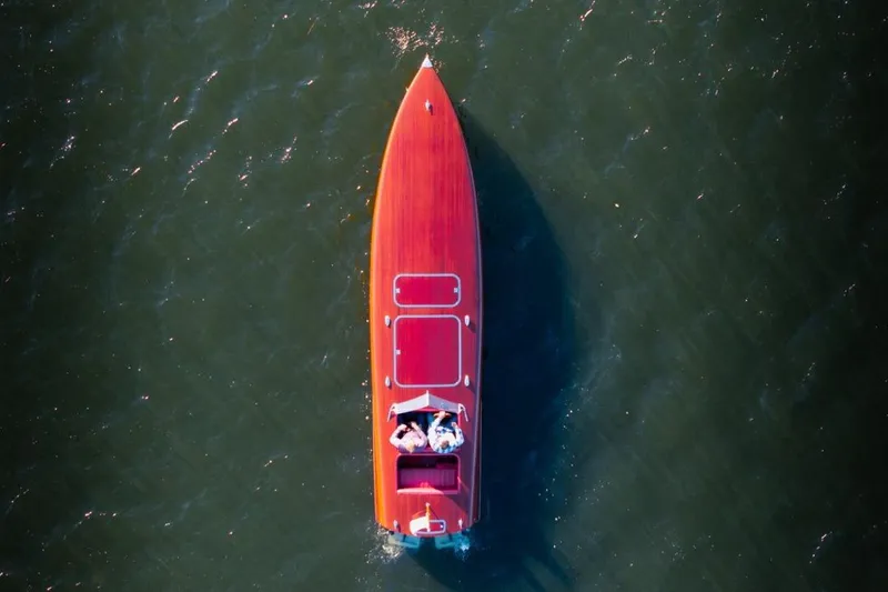 Slide: The Image of Aerial view of a 1998 Custom 30 Gentleman's Racer on water. - 11