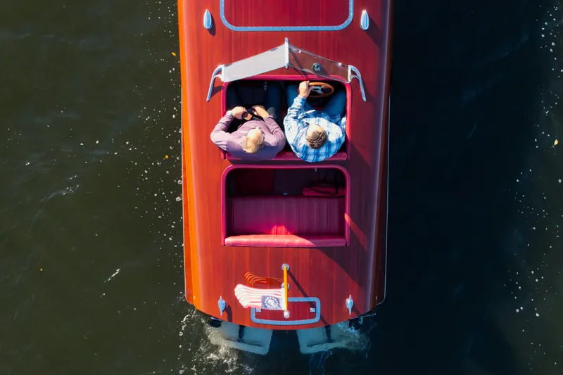Slide: The Image of Overhead view of a 1998 Custom 30 Gentleman's Racer on water with two passengers. - 12