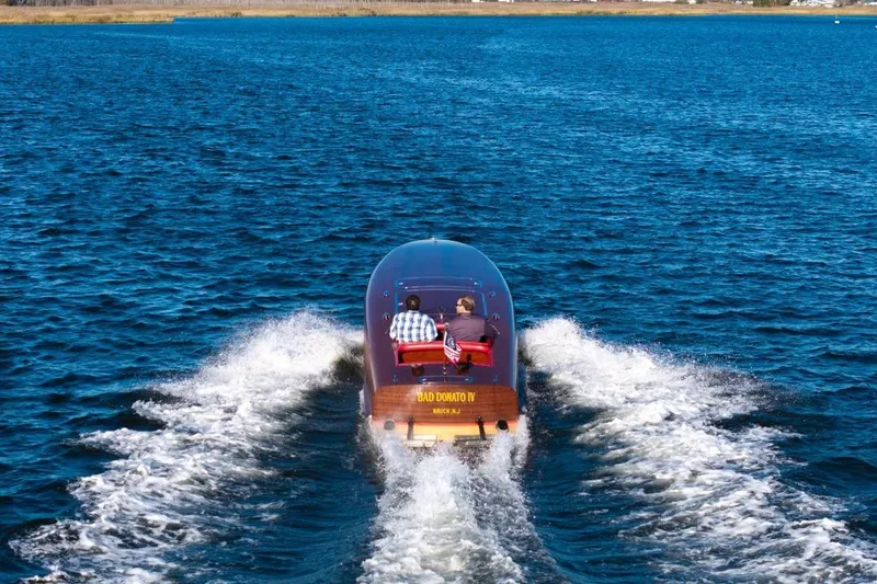 Slide: The Image of Custom 30 Gentleman's Racer boat cruising on open water, 1998 model. - 14