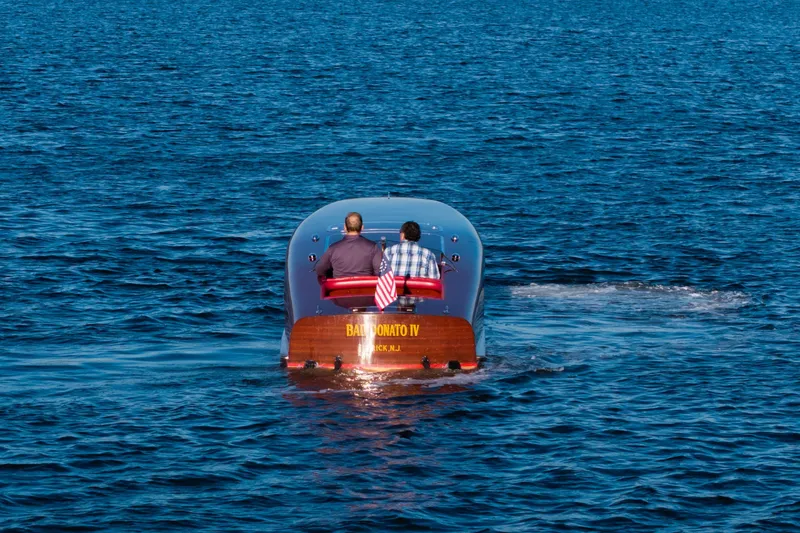 Slide: The Image of Custom 30 Gentleman's Racer boat from 1998 on open water, rear view. - 2