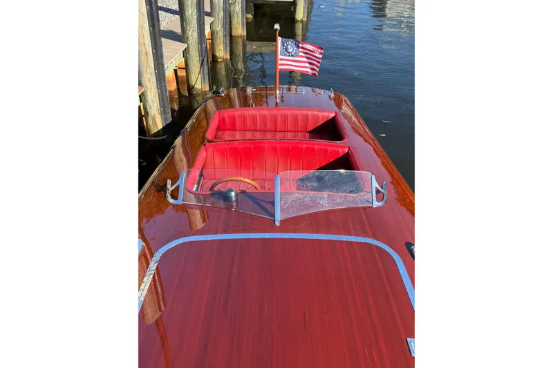 Slide: The Image of Custom 1998 30 Gentleman's Racer with polished wood finish and red interior, docked by water. - 23