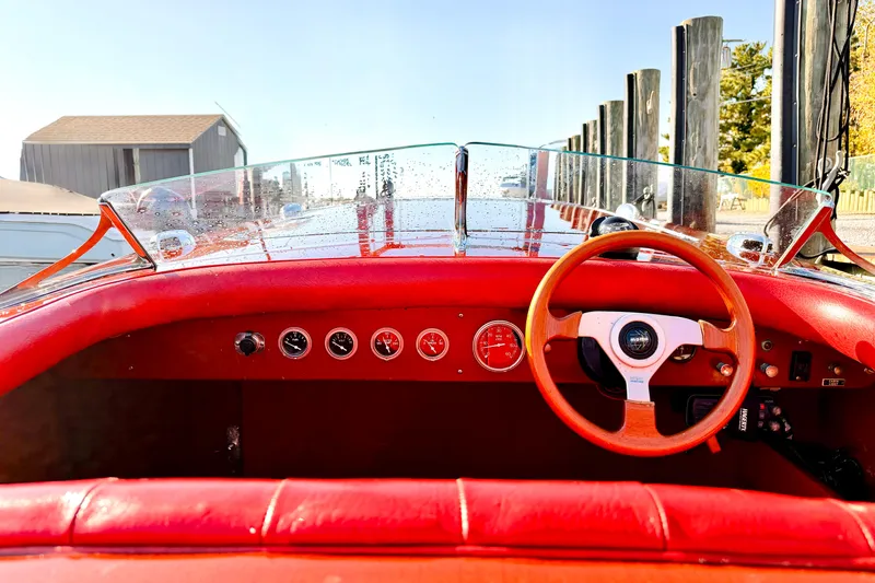 Slide: The Image of Interior of a 1998 Custom 30 Gentleman's Racer with red dashboard and wooden steering wheel. - 28