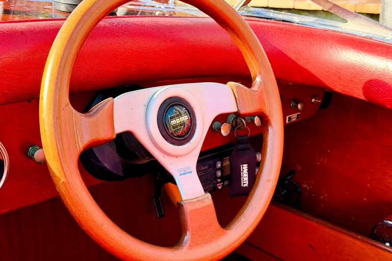 Slide: The Image of Wooden steering wheel of a 1998 Custom 30 Gentleman's Racer with red leather interior. - 29