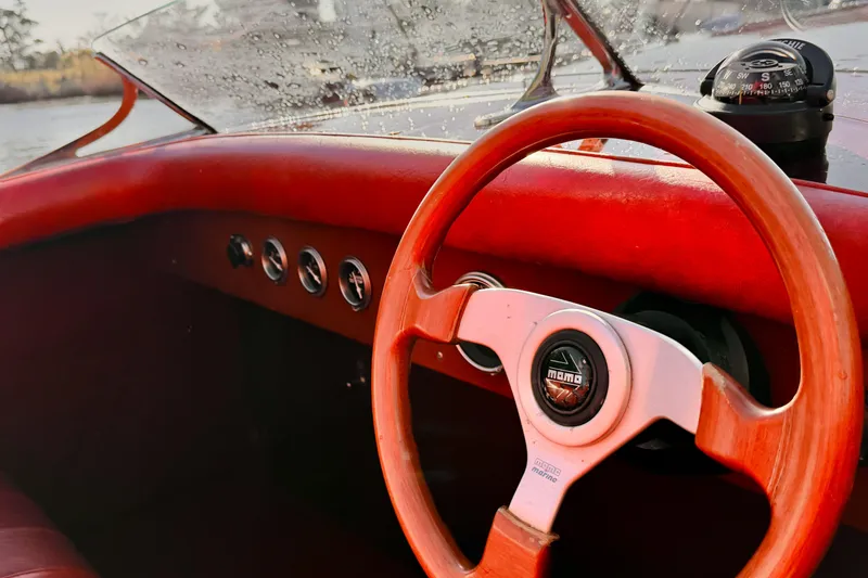 Slide: The Image of Interior of a 1998 Custom 30 Gentleman's Racer with wooden steering wheel and compass. - 30