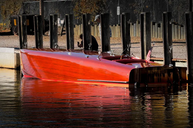 Slide: The Image of Custom 1998 30 Gentleman's Racer boat docked, reflecting sunlight on water. - 32