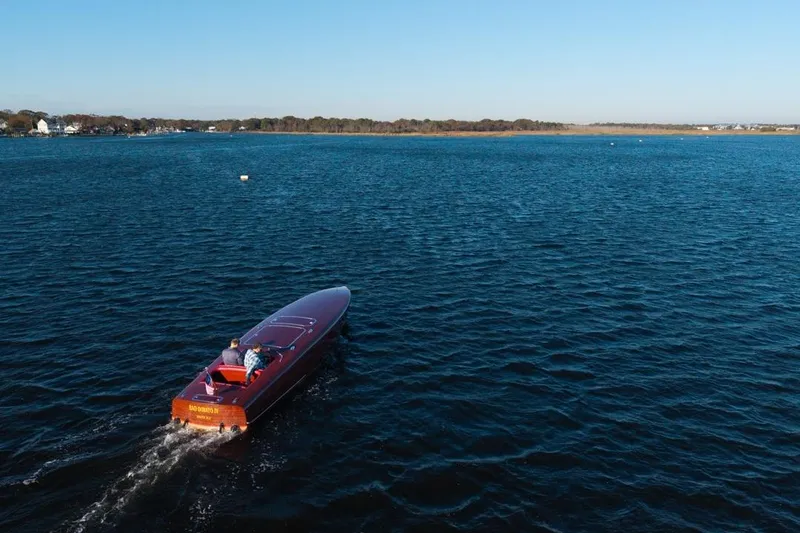 Slide: The Image of Custom 1998 30 Gentleman's Racer cruising on a serene lake under clear blue skies. - 6