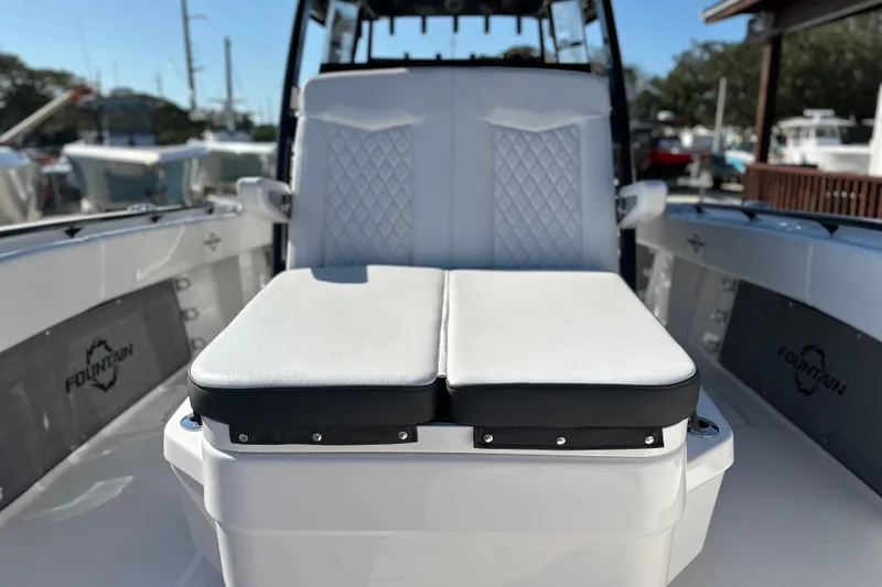 Slide: The Image of 2024 Fountain 34 Tournament Edition boat interior with white cushioned seating. - 8