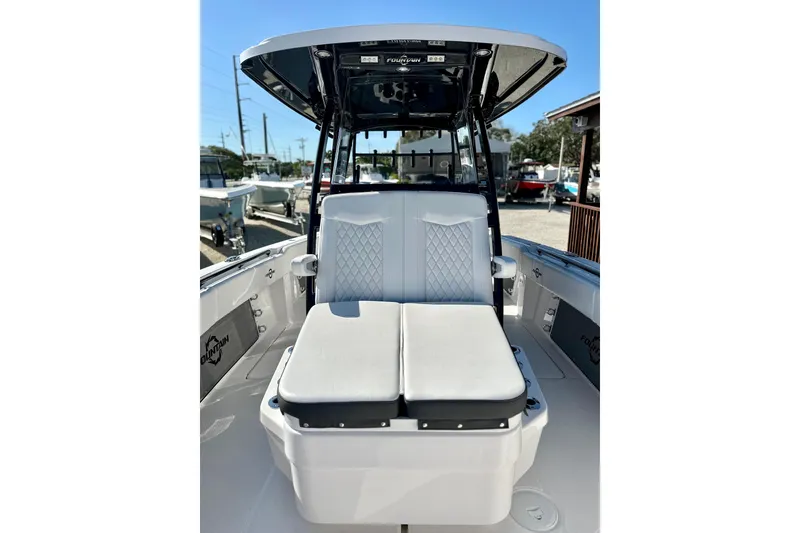Slide: The Image of 2024 Fountain 34 Tournament Edition boat interior with cushioned seating and sleek design. - 9