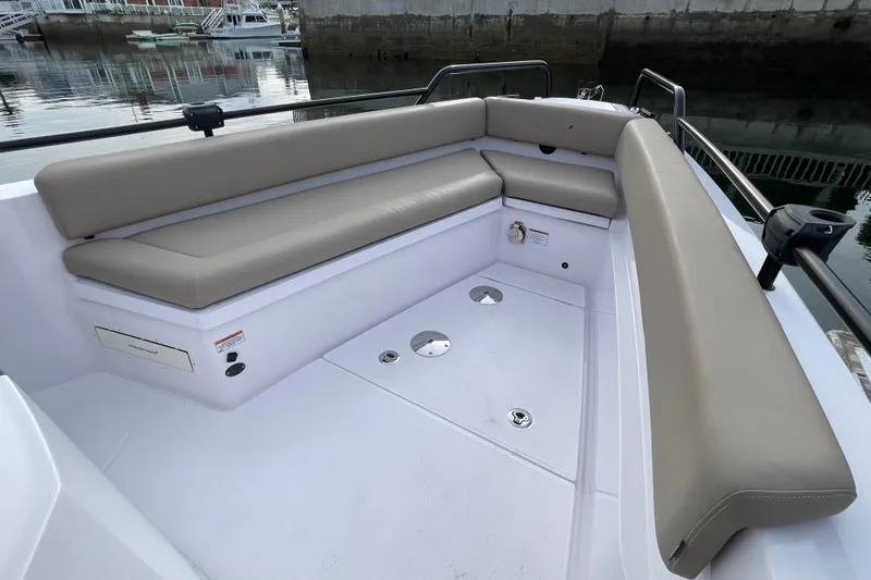 Slide: The Image of Interior of 2023 Axopar 28 Cabin with beige seating. - 11