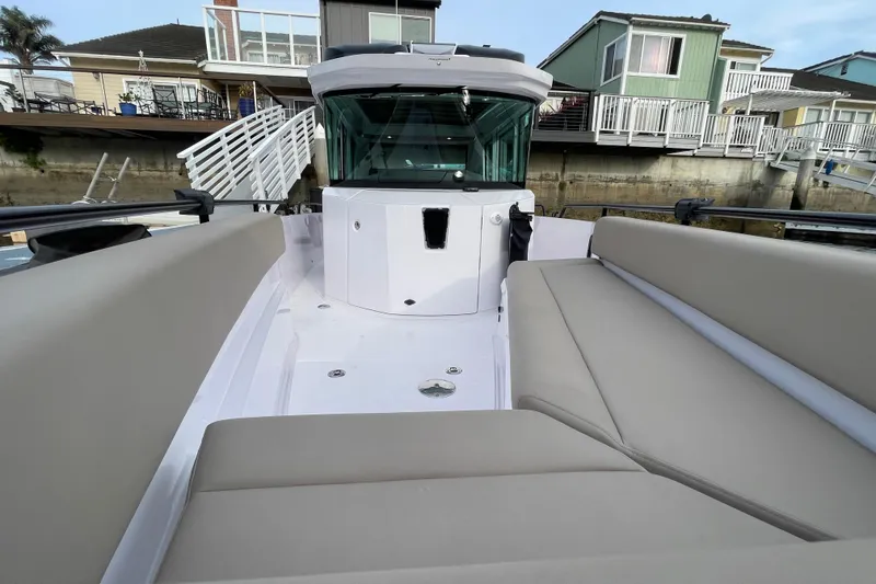 Slide: The Image of Axopar 28 Cabin 2023 with beige seating and modern design. - 13