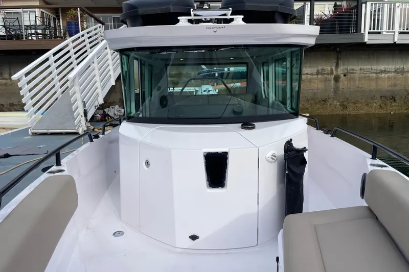 Slide: The Image of Axopar 28 Cabin 2023, modern boat roof and cockpit. - 14