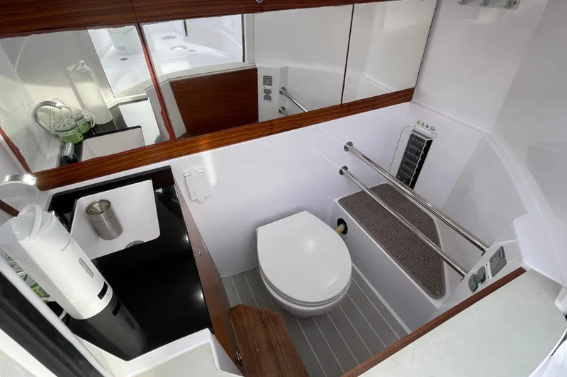 Slide: The Image of Interior of 2023 Axopar 28 Cabin with toilet and sink. - 16