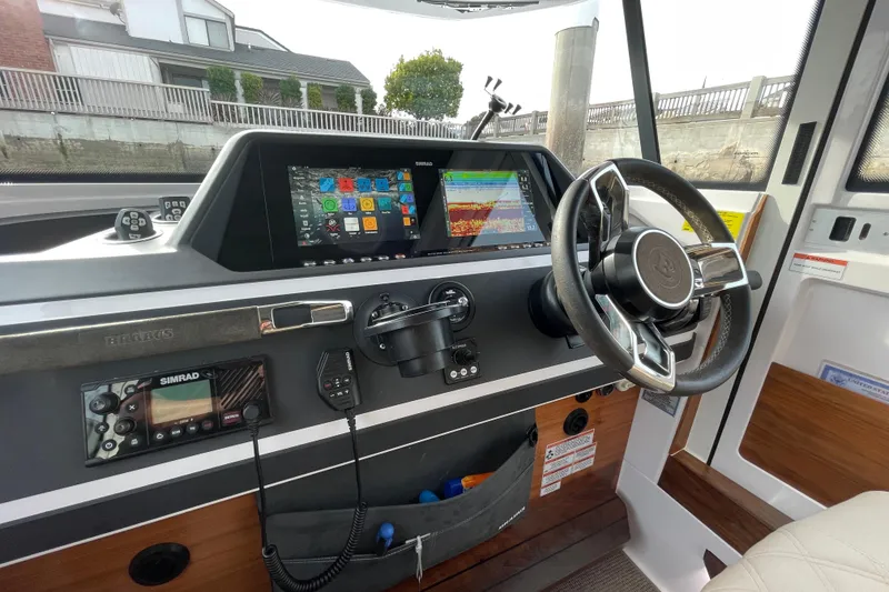 Slide: The Image of 2023 Axopar 28 Aft Cabin with Brabus Trim dashboard featuring advanced navigation systems. - 17
