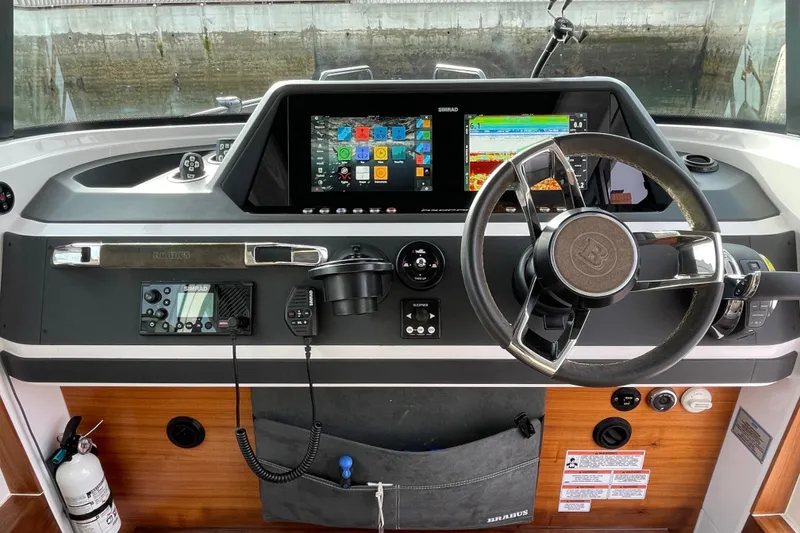 Slide: The Image of Axopar 28 Cabin 2023 helm with modern electronics and controls. - 19