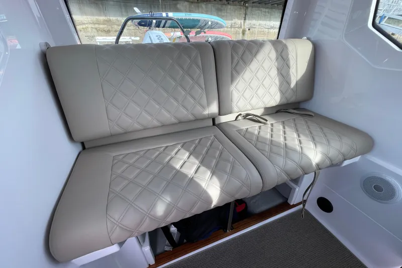 Slide: The Image of Interior of 2023 Axopar 28 Cabin with quilted seats. - 23