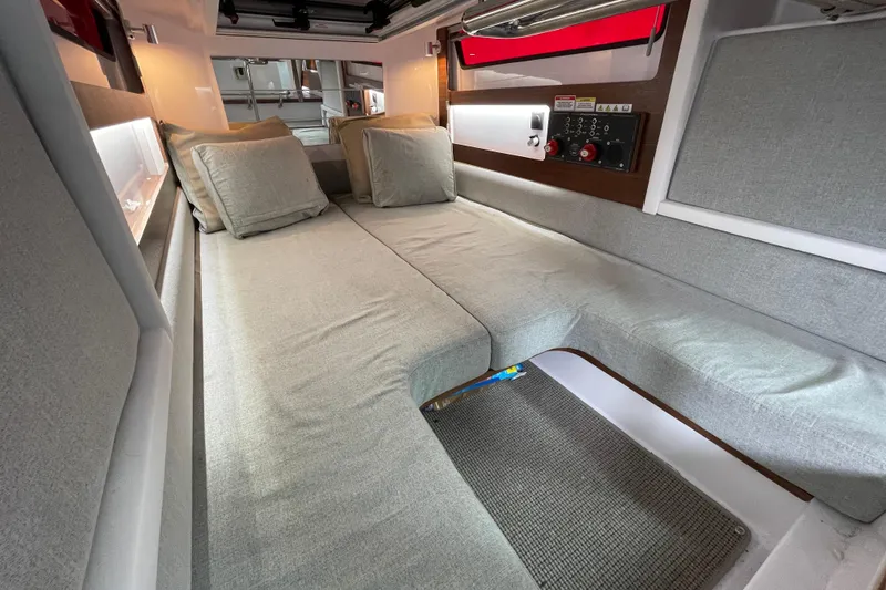 Slide: The Image of Interior of 2023 Axopar 28 Cabin with gray upholstery. - 25